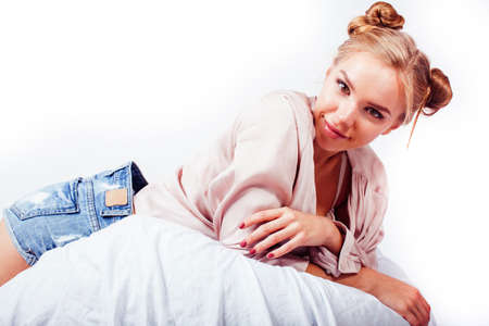 young pretty blond woman laying in bed isolated on white background, lifestyle people conceptの写真素材