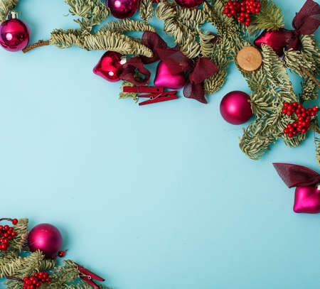christmass stuff laying flat on colorful background, branch of tree, balls, candyの写真素材