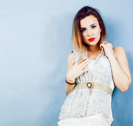 young pretty woman with blond hair on blue background, sensual make up elegant lookの写真素材