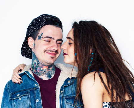 Young couple together. guy with tattoo, girlfriend wearing dreadlocks having fun on white backgroundの写真素材