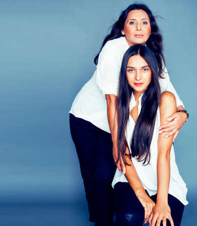 cute pretty teen daughter with mature mother hugging, fashion style brunette, lifestyle people conceptの写真素材