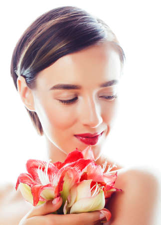 young pretty brunette real woman with red flower amaryllis isolated on white backgroundの写真素材