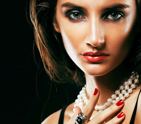 beauty rich woman with bright makeup wearing luxury jewellery on black background, fashion ladyの写真素材