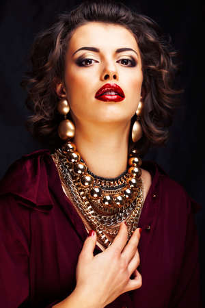 beauty rich woman with bright makeup wearing luxury jewellery on black background, fashion ladyの写真素材