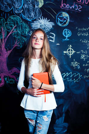 back to school after summer vacations, cute teen girl in classroomの写真素材