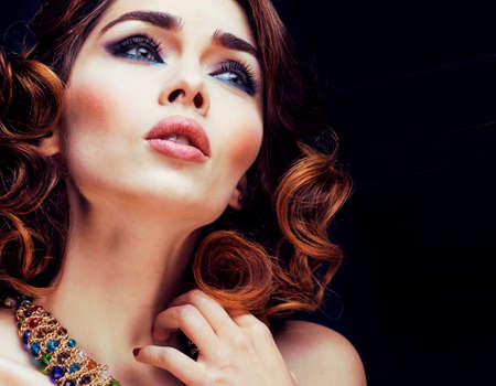 beauty rich woman with bright makeup wearing luxury jewellery on black background, fashion lady curly hairstyleの写真素材