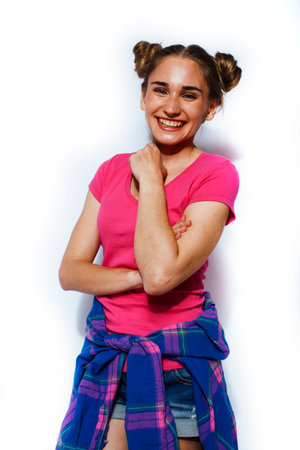 young pretty teenage hipster girl posing emotional happy smiling on white background, lifestyle people conceptの写真素材
