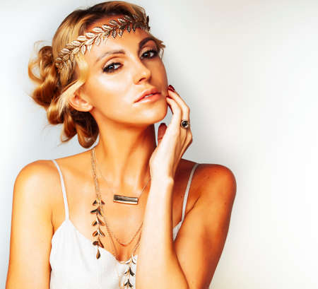 young blond woman dressed like ancient greek godess, gold jewelry closeup isolated, beautiful girl hands manicured red nailsの写真素材