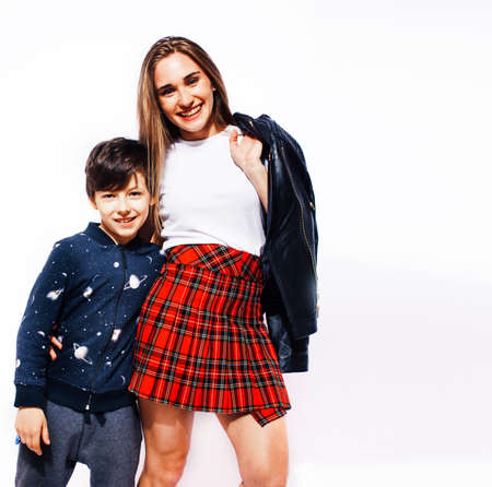 lifestyle and people concept, little cute boy with teenage girl posing together cheerful happy smiling isolated on white backgroundの写真素材