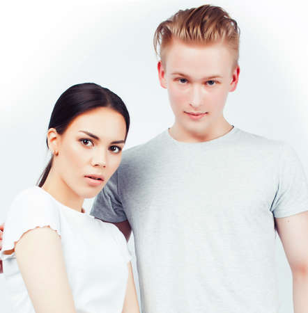 modern hipster guys together couple diverse nations, asian girl and caucasian blond boy isolated on white background, lifestyle people conceptの写真素材