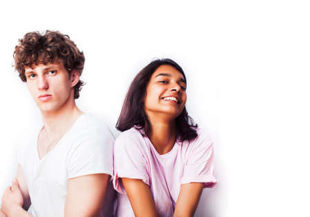 best friends teenage girl and boy together having fun, posing emotional on white background, couple happy smiling, lifestyle people concept, blond and brunette multi nationsの写真素材