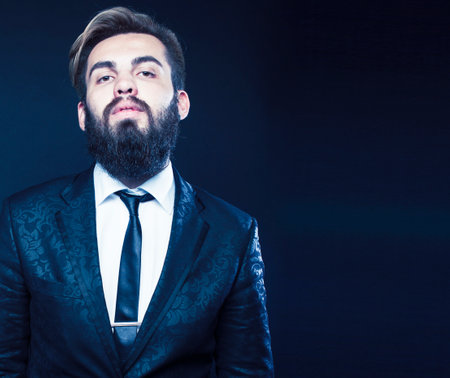 young attractive bearded hipster man gesturing emotional screaming in studio sucsess. fashion modern brutal guyの写真素材