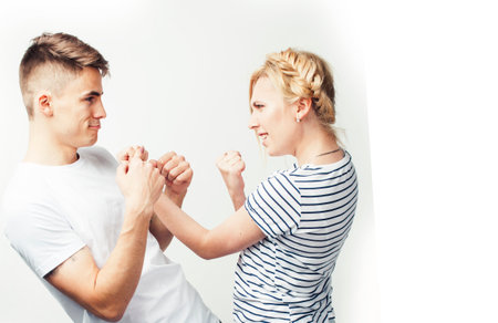 young pretty teenage couple, hipster guy with his girlfriend happy smiling and hugging isolated on white background, lifestyle people conceptの写真素材