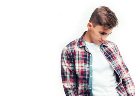 young handsome teenage hipster guy posing emotional, happy smiling against white background isolated, lifestyle people conceptの写真素材