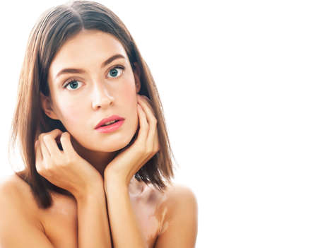 beautiful young brunette woman with vitiligo disease close up isolated on whiteの写真素材