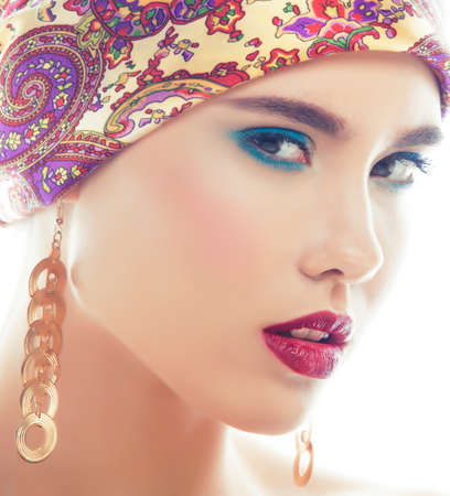 young pretty modern girl with bright shawl on head emotional posing isolated on white background, asian people ethnicityの写真素材