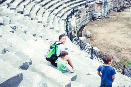 mother with little sons on vacation visiting ancient colosseum, summer tourism, lifestyle people conceptの写真素材