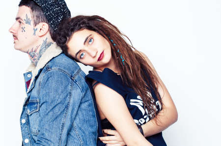Young couple together. guy with tattoo, girlfriend wearing dreadlocks having fun on white backgroundの写真素材