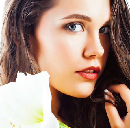 young pretty woman with big white flower close up isolated on white, hands manicure, spa people conceptの写真素材