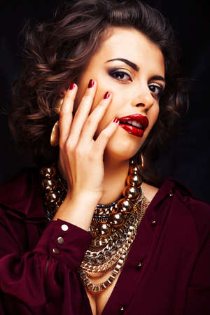 beauty rich woman with bright makeup wearing luxury jewellery on black background, fashion ladyの写真素材
