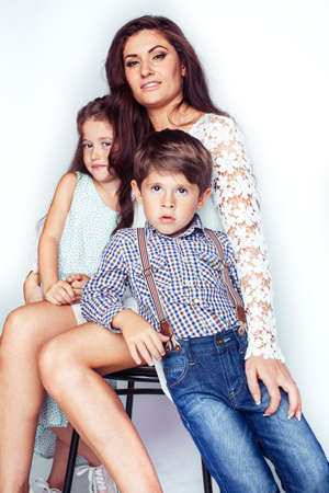 young mother with two children on white background isolated, happy smiling family, lifestyle people conceptの写真素材