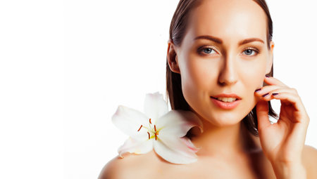 young pretty woman with big white flower close up isolated on white, hands manicure, spa people conceptの写真素材