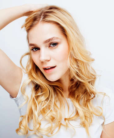 young pretty stylish hipster blond girl posing emotional isolated on white background happy smiling cool smile, lifestyle people conceptの写真素材