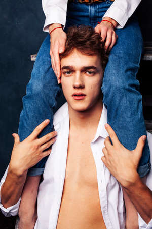 young pretty boy and girl legs on him, relationship concept, lifestyle people conceptの写真素材