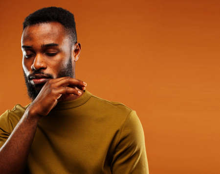 young pretty african american man posing cheerful on brown background, lifestyle people conceptの写真素材