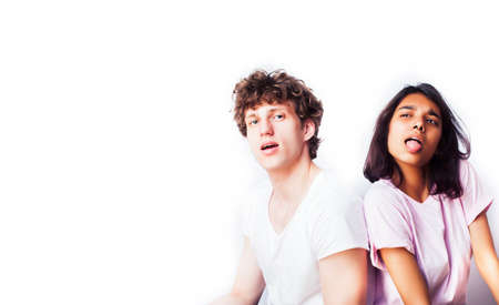 best friends teenage girl and boy together having fun, posing emotional on white background, couple happy smiling, lifestyle people concept, blond and brunette multi nationsの写真素材