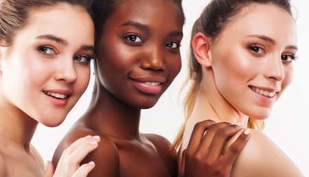 three different nation woman: african-american, caucasian together isolated on white background happy smiling, diverse type on skin, lifestyle real people conceptの写真素材