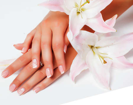 manicure pedicure with flower lily close up isolated on white perfect shape hands spa salonの写真素材