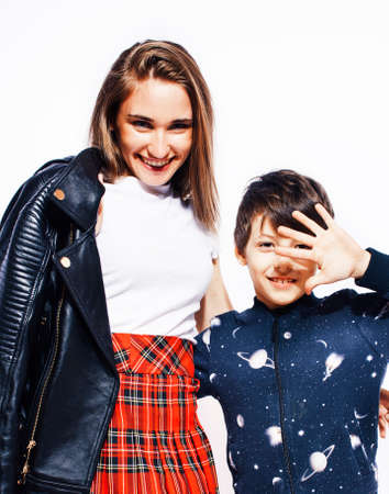 lifestyle and people concept, little cute boy with teenage girl posing together cheerful happy smiling isolated on white backgroundの写真素材