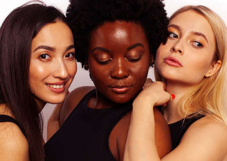 different nation woman: african-american, caucasian, asian together isolated on white background happy smiling, diverse type on skin, lifestyle people conceptの写真素材