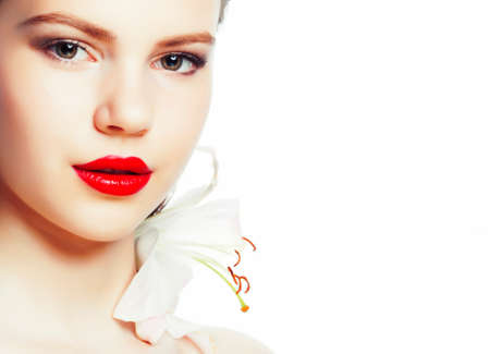 young brunette woman close up isolated on white background with flower, spa healthcare people conceptの写真素材