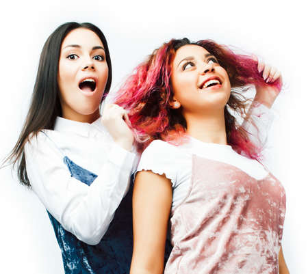 best friends teenage girls together having fun, posing emotional isolated on white background, asian and latin american woman cheerful, lifestyle people conceptの写真素材