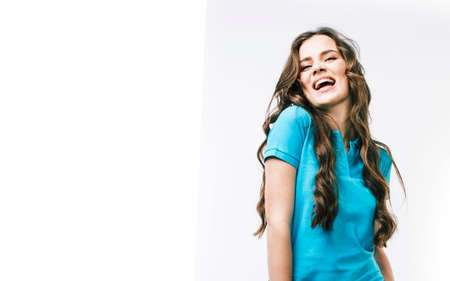 young pretty brunette real girl hipster on white background casual close up dreaming isolated smiling close upの写真素材