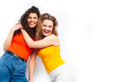 young pretty teenage girls friends with blond and brunette curly hairs posing cheerful isolated on white background, lifestyle people conceptの写真素材
