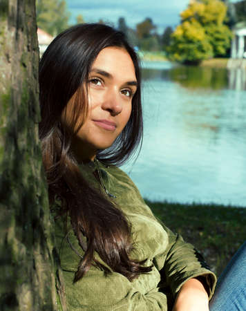 Young cute smiling real stylish dressed woman in green palm park smiling, resting, enjoing, lifestyle outside conceptの写真素材