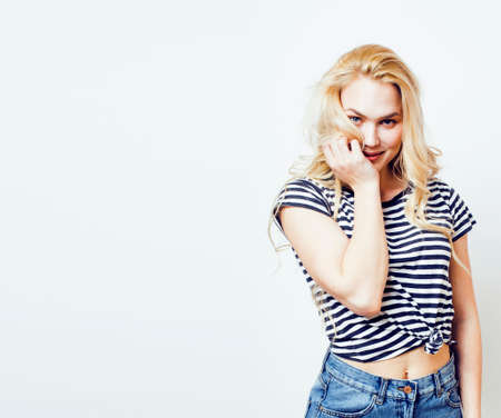 young pretty teenage hipster girl posing emotional happy smiling on white background, lifestyle people concept closeupの写真素材