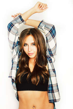 young pretty brunette real girl hipster on white background casual close up dreaming isolated smilingの写真素材
