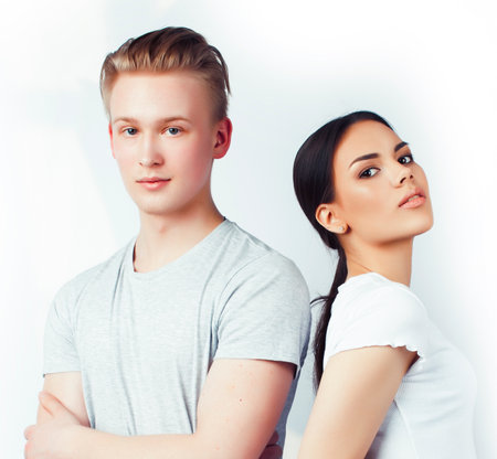 modern hipster guys together couple diverse nations, asian girl and caucasian blond boy isolated on white background, lifestyle people conceptの写真素材