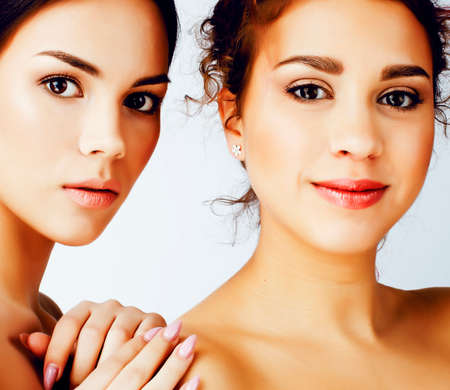 young pretty multiethnic woman posing together cheerful isolated on white background, asian and caucasian diversity in people, cosmetic conceptの写真素材