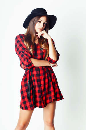 young pretty brunette girl hipster in hat on white background casual close up dreaming smilingの写真素材