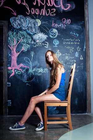 back to school after summer vacations, cute teen girl in classroomの写真素材