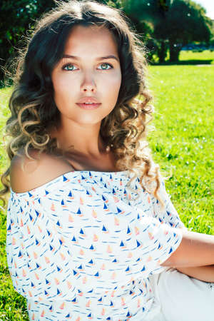 young cute summer girl on green grass outside relaxing smiling, lifestyle people conceptの写真素材