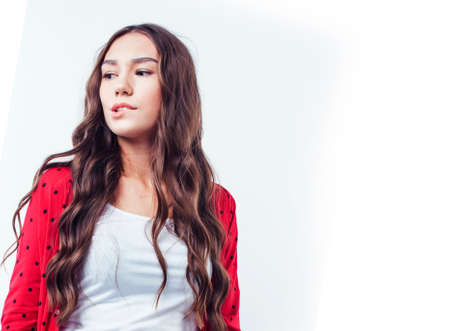 young pretty brunette real girl hipster on white background casual close up dreaming isolated smiling close upの写真素材