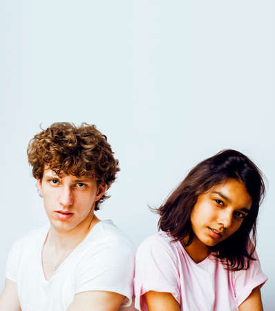 best friends teenage girl and boy together having fun, posing emotional on white background, couple happy smiling, lifestyle people concept, blond and brunette multi nationsの写真素材