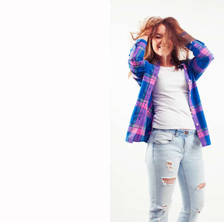 young pretty brunette real girl hipster on white background casual close up dreaming isolated smilingの写真素材