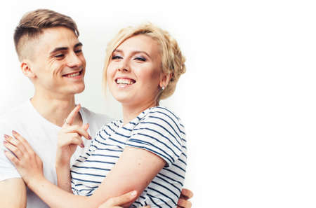 young pretty teenage couple, hipster guy with his girlfriend happy smiling and hugging isolated on white background, lifestyle people conceptの写真素材